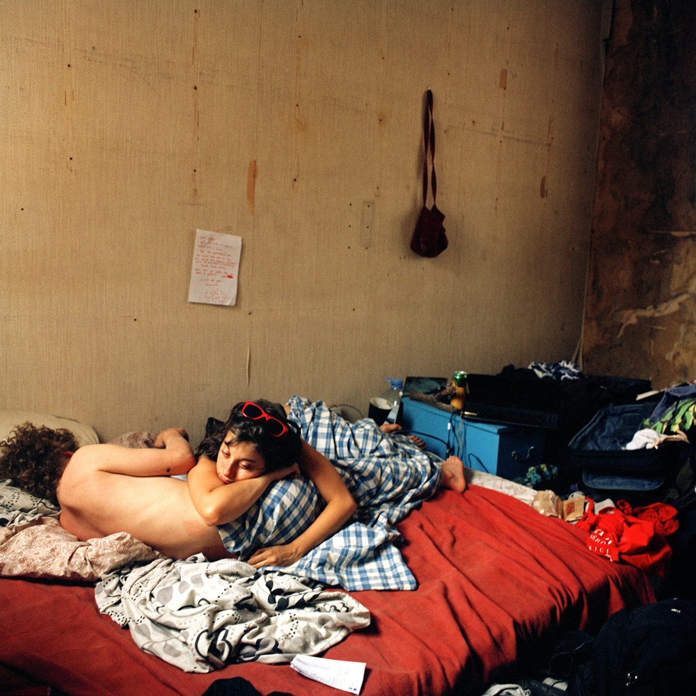 Joe and Giovana in bed, they live together in a squat where they first met, from the series In Between Dreams, London, 2010 met, from the series In Between Dreams, London, 2010